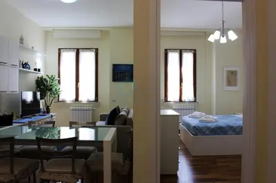 a living room and kitchen with a bed and a table at Your Perfect Roman Getaway in Vatican in Rome
