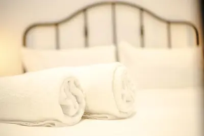 two white bunk beds with white towels on them at Magikrooms Kandy in Rome