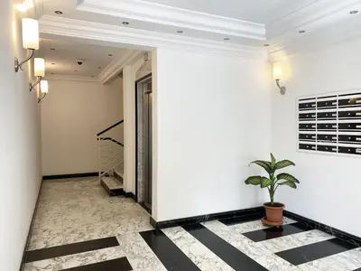 a hallway with black and white flooring and a potted plant at Be Close - Porta Portese Appartamento con terrazza in Rome