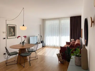 a living room with a table and a couch at Be Close - Porta Portese Appartamento con terrazza in Rome