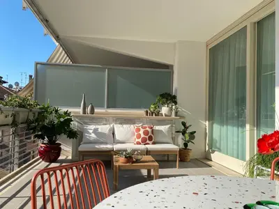 a balcony with a couch and a table and chairs at Be Close - Porta Portese Appartamento con terrazza in Rome