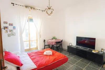 a bedroom with a bed and a table and a television at Di Donato Apartment in Rome