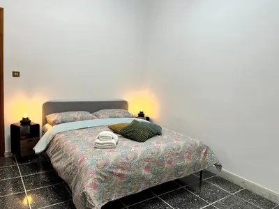 a bedroom with a bed with two towels on it at Di Donato Apartment in Rome