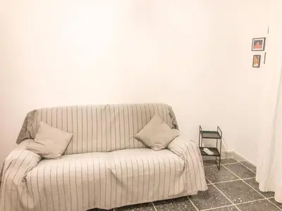 a couch with two pillows sitting in a room at Di Donato Apartment in Rome