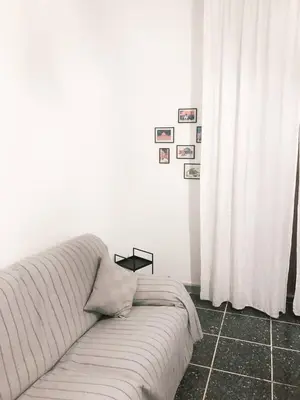 a living room with a couch and a white curtain at Di Donato Apartment in Rome