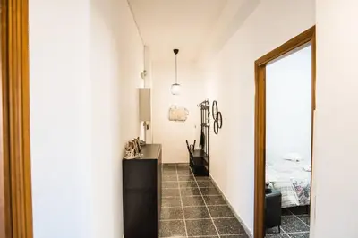 a hallway with a mirror and a bed at Di Donato Apartment in Rome