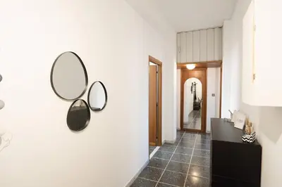a hallway with two mirrors on the wall at Di Donato Apartment in Rome