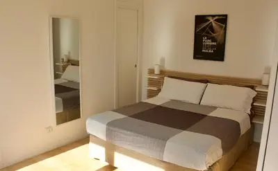 a bedroom with a bed and a large mirror at Quadrilatero Flat in Rome