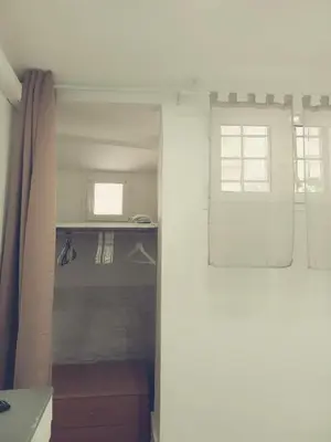a white room with a window and a curtain at Il barone di Trastevere in Rome
