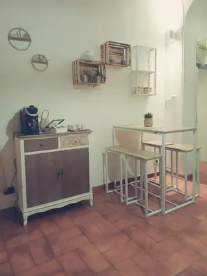 a kitchen with a table and some chairs and a counter at Il barone di Trastevere in Rome