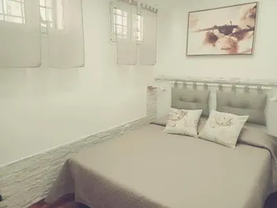 a white bedroom with a large white bed with pillows at Il barone di Trastevere in Rome