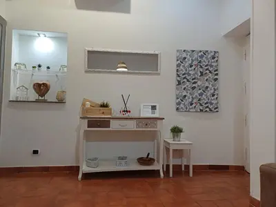 a living room with white walls and a table at Il barone di Trastevere in Rome