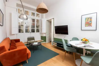 a living room with a orange couch and a table at Piazza Cavour Zen Garden-ZEN36 in Rome