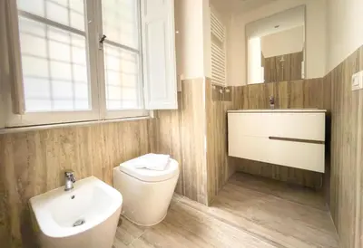 a bathroom with a toilet and a sink and a mirror at Piazza Cavour Zen Garden-ZEN36 in Rome