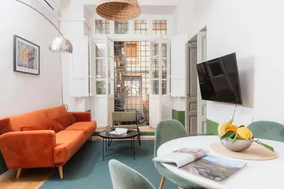 a living room with a couch and a table at Piazza Cavour Zen Garden-ZEN36 in Rome