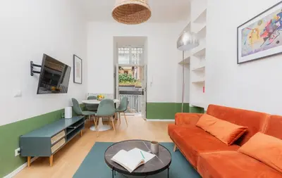 a living room with a couch and a table at Piazza Cavour Zen Garden-ZEN36 in Rome