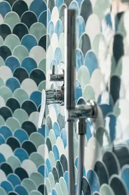 a bathroom with a wall with blue and white tiles at Circolo degli Scipioni in Rome