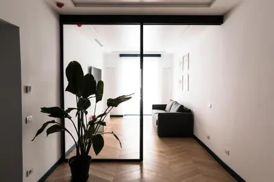 a living room with a glass door and a plant at Circolo degli Scipioni in Rome