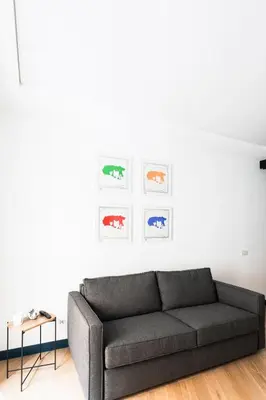 a living room with a couch and art on the wall at Circolo degli Scipioni in Rome