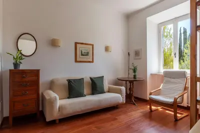 a living room with a couch and a chair at Casa Augusto - Charme Holidays in Rome