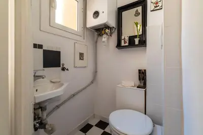 a bathroom with a toilet and a sink at Casa Augusto - Charme Holidays in Rome