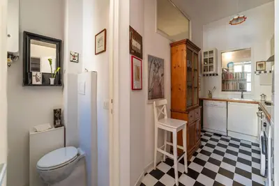 a bathroom with a toilet and a black and white checkered floor at Casa Augusto - Charme Holidays in Rome