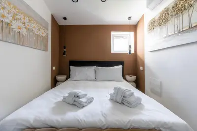 a bedroom with a bed with two towels on it at MauveSweetRhome 3 in Rome