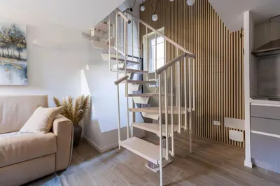 a spiral staircase in a living room with a couch at MauveSweetRhome 3 in Rome