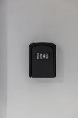 a black wall clock on a white wall at MauveSweetRhome 3 in Rome
