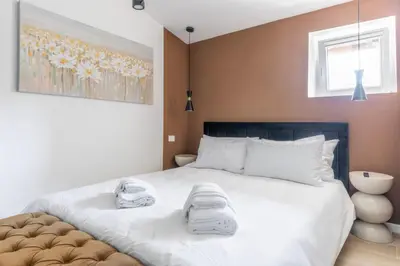 a bedroom with a large bed with towels on it at MauveSweetRhome 3 in Rome