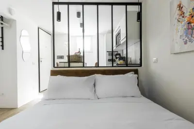 a bedroom with a large window above the bed at MauveSweetRhome 1 in Rome