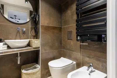 a bathroom with a toilet and a sink and a mirror at MauveSweetRhome 1 in Rome