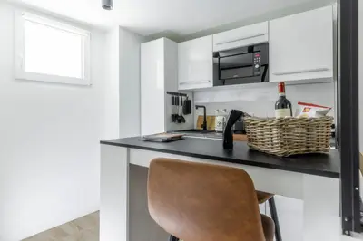 a kitchen with a black counter and a chair at MauveSweetRhome 1 in Rome