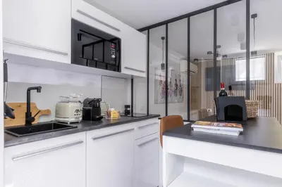 a kitchen with white cabinets and a sink at MauveSweetRhome 1 in Rome
