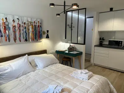 a bedroom with a bed and a table and a kitchen at MauveSweetRhome 4 in Rome