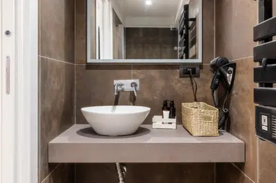 a bathroom with a sink and a mirror at MauveSweetRhome 4 in Rome