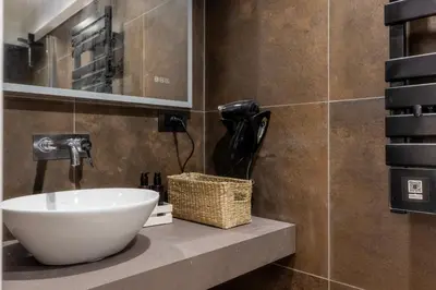 a bathroom with a sink and a phone on a counter at MauveSweetRhome 4 in Rome
