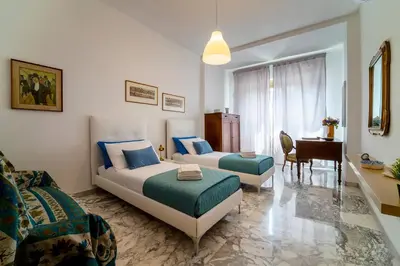 a hotel room with two beds and a piano at Casa Elena - 15 min walk to St Peter's Basilica in Rome