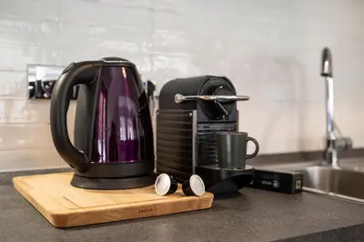 a coffee maker on a cutting board on a kitchen counter at Casa Elena - 15 min walk to St Peter's Basilica in Rome