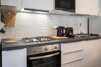 a kitchen with a stove and a sink at Casa Elena - 15 min walk to St Peter's Basilica in Rome
