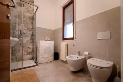 a bathroom with a toilet and a shower and a sink at Casa Elena - 15 min walk to St Peter's Basilica in Rome