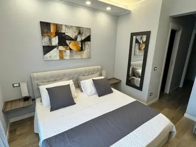 a bedroom with a large white bed with two pillows at Niky House Roma in Rome