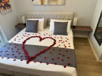 a bed with a heart made out of red pedals at Niky House Roma in Rome