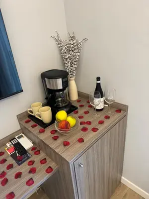 a table with a coffee maker and glasses of wine at Niky House Roma in Rome