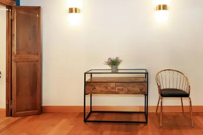 a glass desk with a chair next to a wall at Golden Pantheon Rooms in Rome