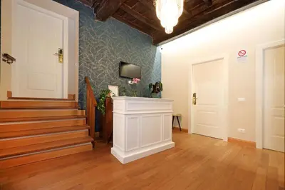 a hallway with a staircase and a tv on a wall at Golden Pantheon Rooms in Rome