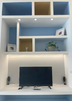 a flat screen tv sitting on a white shelf at Vatican Hill Apt in Rome