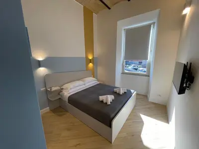 a small bedroom with a bed and a window at Vatican Hill Apt in Rome