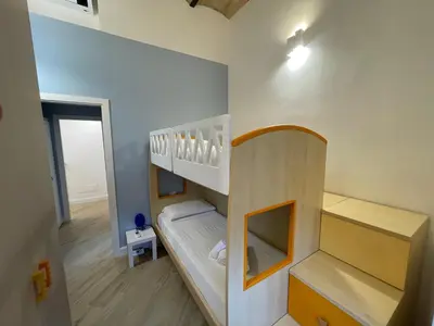 a childs room with a bunk bed and a staircase at Vatican Hill Apt in Rome