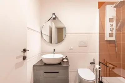 a bathroom with a sink and a mirror at Gracchi boutique rooms in Rome